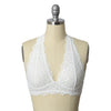 A mannequin wearing a white, lace, halter top bralette.